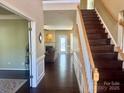 Two-story foyer with hardwood floors and staircase at 6412 Falls Lake Dr, Charlotte, NC 28270