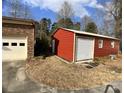 A detached red shed with a roll up garage door at 740 Jackson Rd, Salisbury, NC 28146