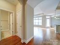 Spacious entryway with gleaming hardwood floors leading to an open-concept living area and a conveniently located powder room at 9029 Treetop Nw Way, Concord, NC 28027