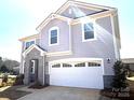 Attractive two-story home boasting a two-car garage, stone facade accents, and modern architectural details at 9934 Cask Way, Huntersville, NC 28078