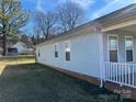 Side view of the house showcasing its light blue siding and backyard at 1004 Johnson St, Charlotte, NC 28206