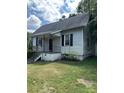 White siding house with a spacious yard needing some landscaping at 1019 W 5Th Ave, Gastonia, NC 28052