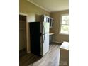 Kitchen features stainless steel refrigerator and gray cabinets at 1019 W 5Th Ave, Gastonia, NC 28052