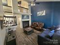 Inviting living room boasting soaring ceilings, modern fireplace and stylish finishes at 10904 Pimlico Dr, Charlotte, NC 28273