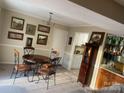 Inviting dining area featuring a wooden table and chairs complemented by elegant decor and ample sunlight at 11306 Kingfisher Dr, Charlotte, NC 28226