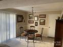 Bright dining area with natural light, decorative artwork, and a classic chandelier above the round table at 11306 Kingfisher Dr, Charlotte, NC 28226