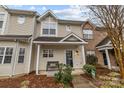 Attractive tan townhome featuring a covered entryway and landscaping at 12250 Savannah Garden Dr, Charlotte, NC 28273