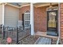 Close up of a front porch with rocking chairs, decorative door, and brick at 12527 Cedar Post Ln, Charlotte, NC 28215