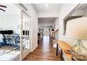 Bright hallway featuring wood floors, white walls, and an office space visible through glass doors at 1328 Lena St, Monroe, NC 28112