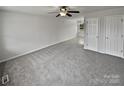 Spacious living room with gray carpeting and neutral walls at 165 Bowman Rd, Statesville, NC 28625