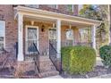 Front porch with brick steps, white columns, and black railing at 209 Squirrel Ln, Lake Wylie, SC 29710