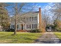 Two-story house with gray shutters, a brick walkway, and American flag at 2228 Valencia Ter, Charlotte, NC 28226