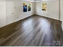 Bright living room featuring new vinyl plank flooring and neutral walls at 333 S High St, Waxhaw, NC 28173