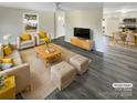 Spacious living room with wood-look floors, and staged furniture at 333 S High St, Waxhaw, NC 28173