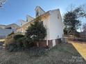 Side view of the house showing a deck and landscaping at 3462 Lake Shore S Dr, Denver, NC 28037