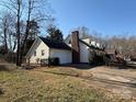 House exterior showcasing a large backyard and driveway at 3462 Lake Shore S Dr, Denver, NC 28037