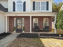 Inviting front porch with brick accents and seating, perfect for relaxing outdoors at 3865 Parkers Ferry Rd, Fort Mill, SC 29715