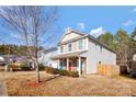 Two-story house with stone accents and a fenced backyard at 4152 Broadstairs Sw Dr, Concord, NC 28025