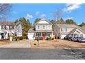 Two-story house with stone accents and a red front door at 4152 Broadstairs Sw Dr, Concord, NC 28025