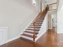 Elegant staircase with wrought iron railings leading to upper level at 4855 Star Hill Ln, Charlotte, NC 28214