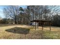 Large backyard with a wooden shelter and mature trees at 510 W Blume St, Landis, NC 28088