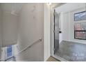 Hallway view leading into the unit, featuring neutral walls, a staircase, and tile flooring at 544 New Bern Station Ct, Charlotte, NC 28209