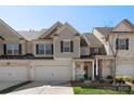 Charming townhome with two-car garage, neutral brick, and stylish gray trim, offering a welcoming curb appeal at 6007 Cadence Ln, Indian Land, SC 29707