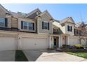 Attractive townhome featuring a two-car garage, well-kept lawn, and inviting entrance on a sunny day at 6007 Cadence Ln, Indian Land, SC 29707