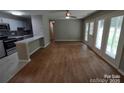 Open floor plan combining living and kitchen areas with hardwood floors at 6106 Meadow Rose Ln, Charlotte, NC 28215