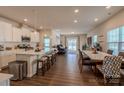 Open concept kitchen with island, white cabinets, and stainless steel appliances at 6525 Gopher Rd, Indian Land, SC 29707