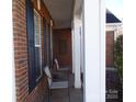 Side view of the front porch with brick columns and chairs at 9018 Kestral Ridge Dr, Charlotte, NC 28269