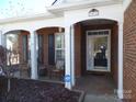 Inviting front porch with brick columns and two chairs at 9018 Kestral Ridge Dr, Charlotte, NC 28269