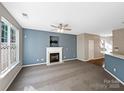 Spacious living room with fireplace, neutral carpeting, and natural light at 908 Coffee Tree Ln, Rock Hill, SC 29732