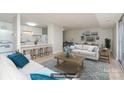 Virtually staged living room with light colored sofa and wooden coffee table at 9325 Old Concord Rd # C, Charlotte, NC 28213