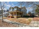 Two-story home with a wrap-around porch, landscaping, and detached garage at 143 Reid St, Rock Hill, SC 29730