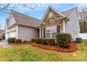 Gray siding home with stone accents and manicured landscaping at 2019 Stoney Point Cir, Monroe, NC 28112