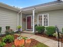 Townhome entrance with landscaping and seasonal decor at 2717 New Hamlin Way, Charlotte, NC 28210