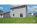 Rear view of house showcasing back yard and sliding glass door at 3259 Maple Ridge Dr, Gastonia, NC 28052
