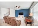 Relaxing living room featuring brown leather couches and a blue accent wall at 3594 Cerelia Ln, Denver, NC 28037