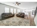 Open concept living room with kitchen view and access to stairs at 3594 Cerelia Ln, Denver, NC 28037