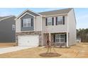 Two-story house with gray and stone accents, a white garage door, and a well-maintained lawn at 3671 Mercer St, Terrell, NC 28682