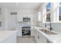 Modern white cabinets, stainless steel appliances, and a stylish sink at 414 W Harvie Ave, Gastonia, NC 28052