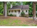 House with a porch and landscaping in a wooded area at 5138 Foley Dr, Hickory, NC 28601