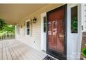 Home's front entrance with a brown door and screen door, and a welcoming mat at 5138 Foley Dr, Hickory, NC 28601