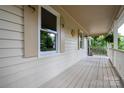 Inviting front porch with wooden flooring, white railings, and decorative shutters at 5138 Foley Dr, Hickory, NC 28601