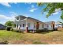 Charming two-story home with a cozy porch and brick detailing at 6037 Pleasant Grove Rd, Charlotte, NC 28216