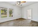 Bright living room with wood-look floors and two large windows at 6037 Pleasant Grove Rd, Charlotte, NC 28216