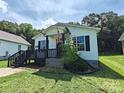 Charming home featuring a cozy front porch with black trim and an American flag at 629 S Caldwell St, Salisbury, NC 28144