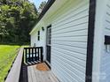 View of a side entrance with a black door and a small wooden porch at 629 S Caldwell St, Salisbury, NC 28144