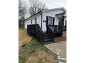 Side view of home with a black porch and access steps on a manicured lawn at 629 S Caldwell St, Salisbury, NC 28144